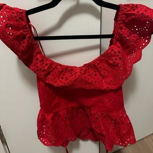 red top that is slightly cropped - short sleeves but fun lace pattern.